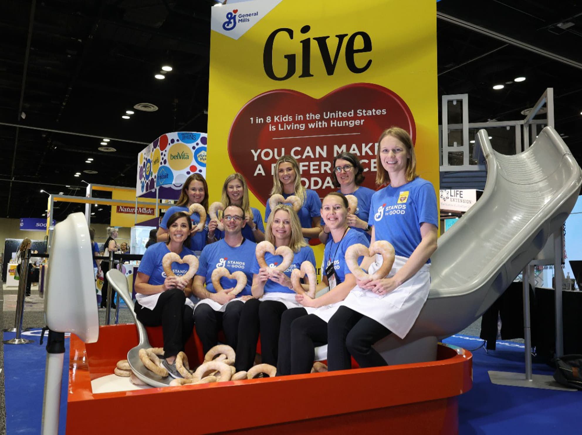 General Mills nutrition team holding Cheerios heart at FNCE booth
